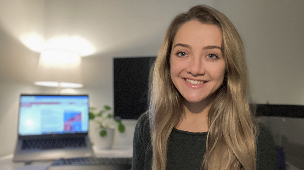 Kathryn Heeg smiles at her remote learning desk at home.